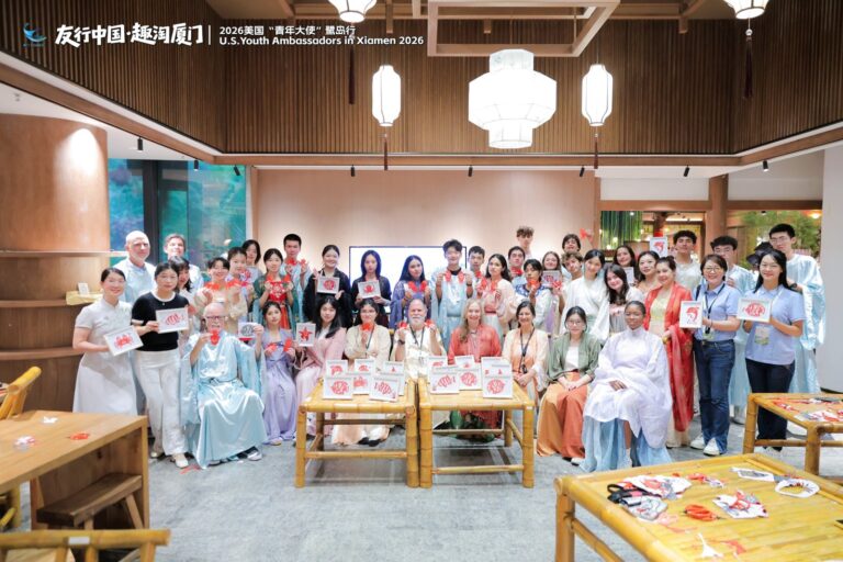 Hanfu and handicrafts workshop, Xiamen Students in traditional Chinese robes behind a long table of craft materials in a wooden hall